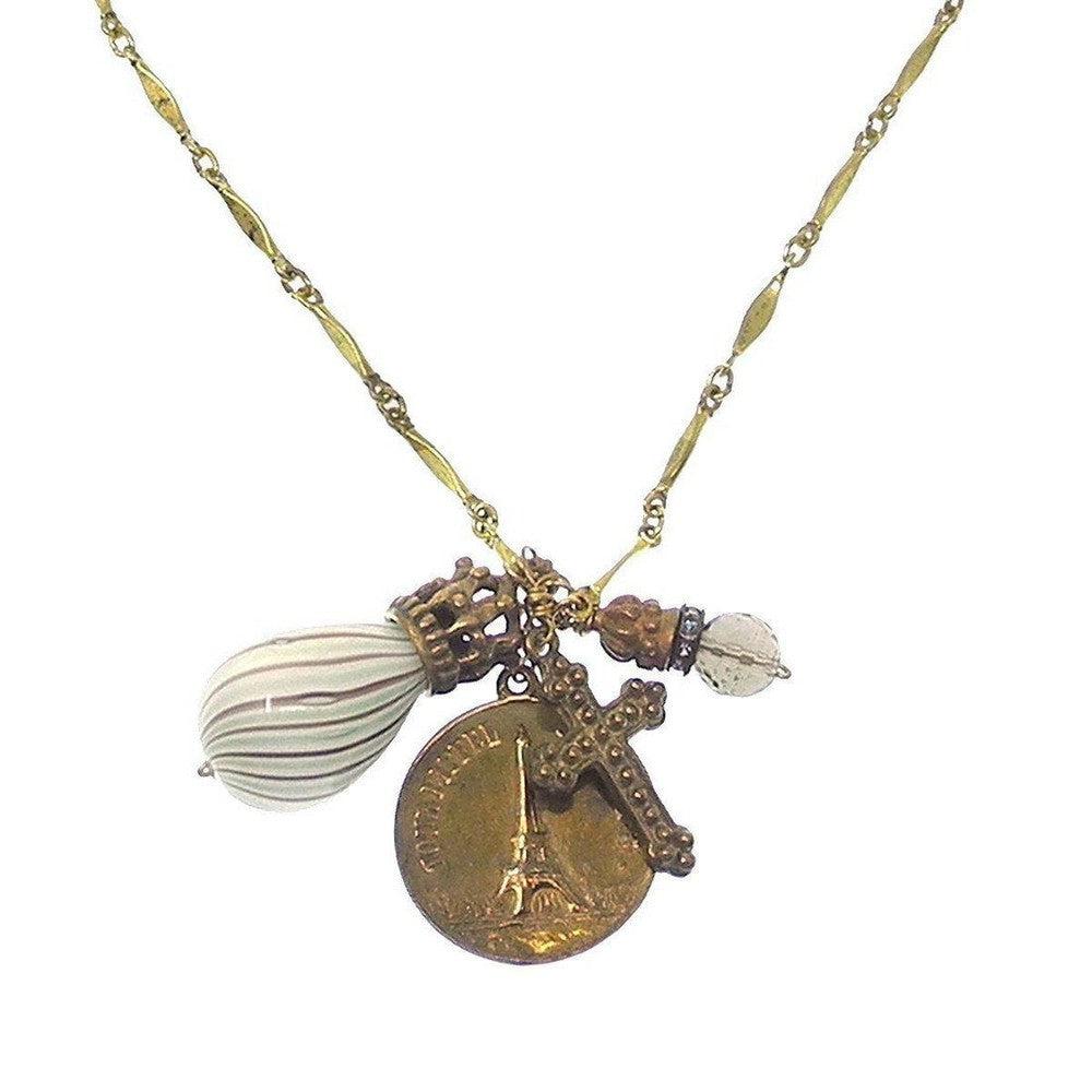Gold chain necklace with Eiffel Tower, cross, and glass charm pendants.
