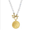 Princess Diana memorial coin pendant on a white pearl necklace with a gold-plated front toggle closure.