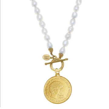 Princess Diana memorial coin pendant on a white pearl necklace with a gold-plated front toggle closure.
