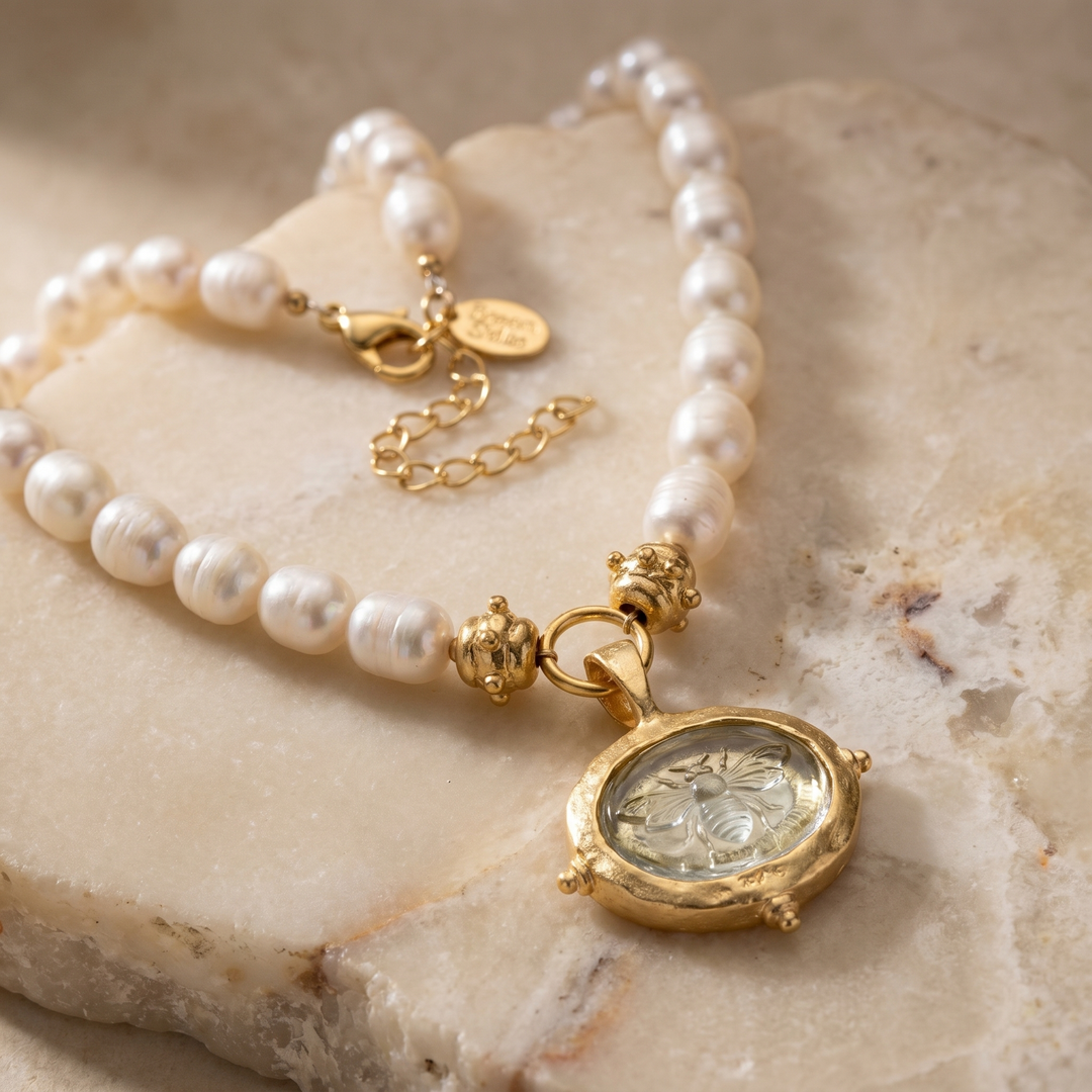 Clear Venetian glass bee intaglio pendant on a genuine freshwater pearl necklace with gold-plated accents.