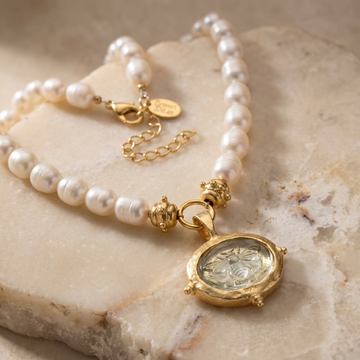 Clear Venetian glass bee intaglio pendant on a genuine freshwater pearl necklace with gold-plated accents.