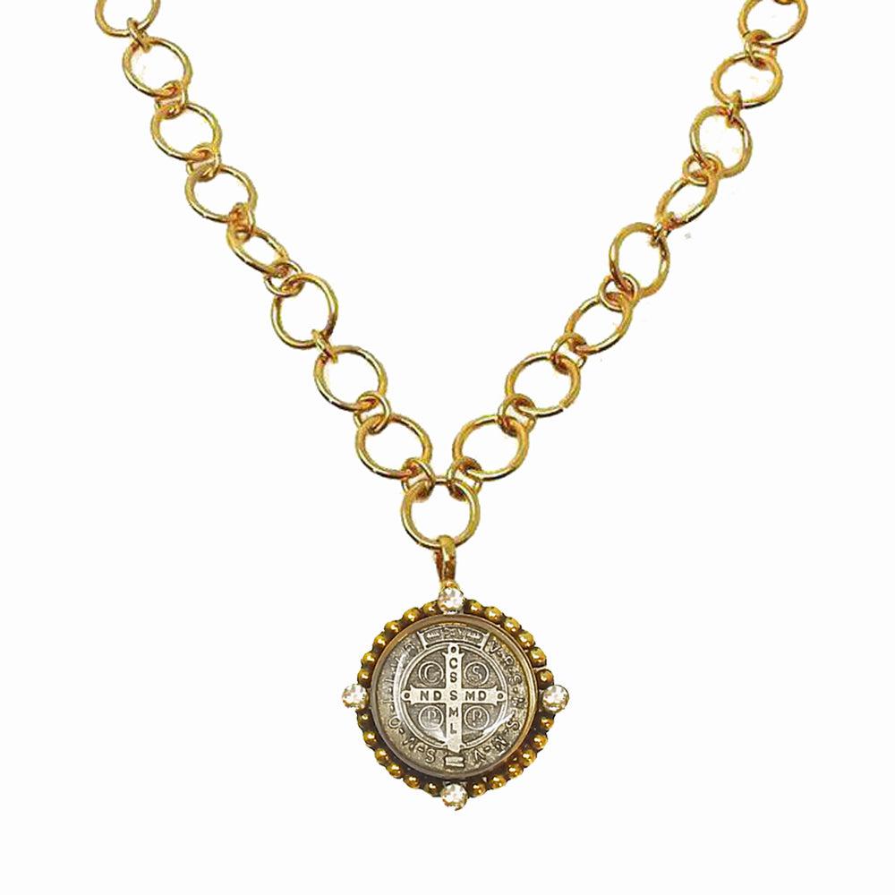 Gold chain necklace with ornate medal pendant featuring clear accents.
