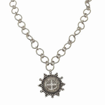 Silver chain necklace featuring a circular medal pendant.
