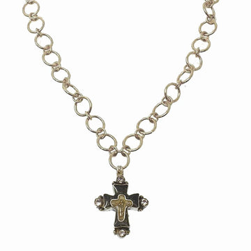 Silver chain necklace featuring a detailed cross pendant with clear stones.
