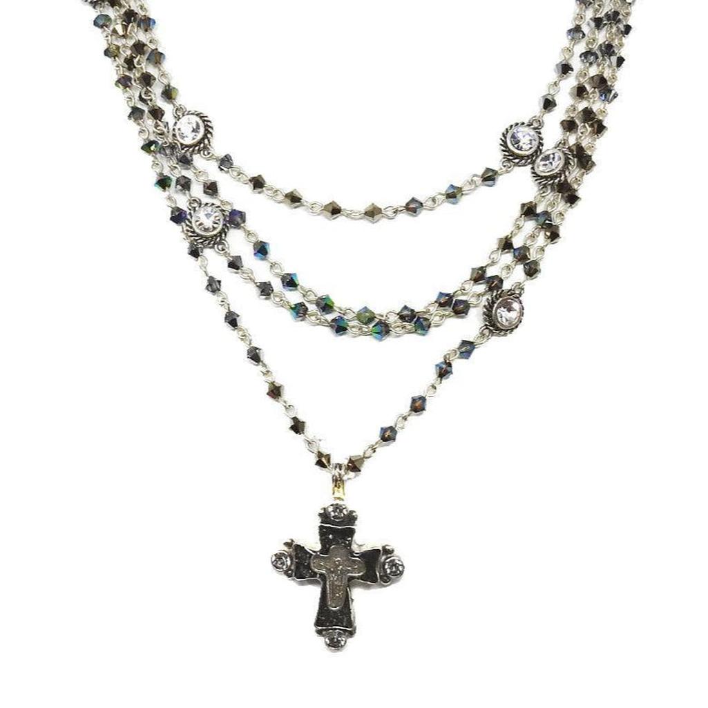 Metallic blue Bicone Magdalena necklace: layered crystal & cross pendant.
