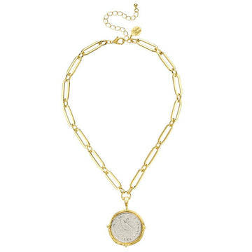 Gold chain necklace featuring a vintage coin pendant.
