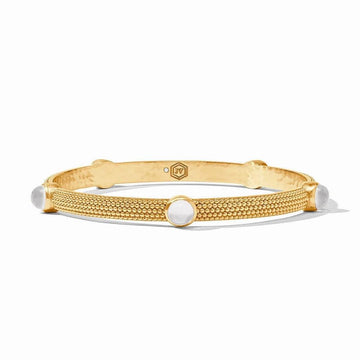 Gold bangle bracelet with textured surface and white cabochon stones.
