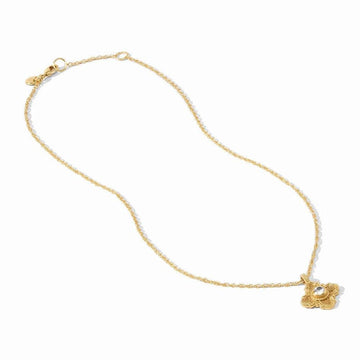 Gold chain necklace with ornate floral pendant featuring a clear solitaire stone.
