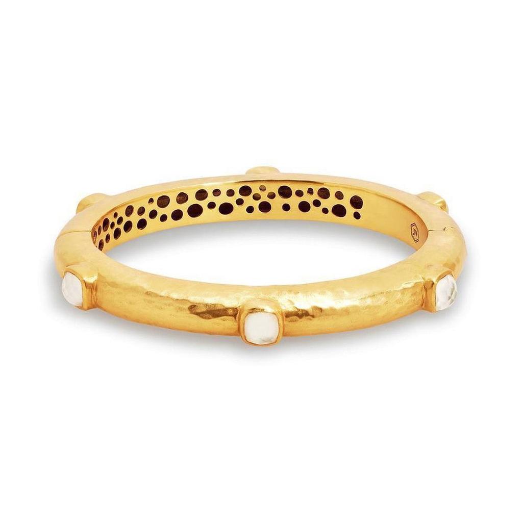 Gold hinged bangle bracelet adorned with gemstones; hammered texture.
