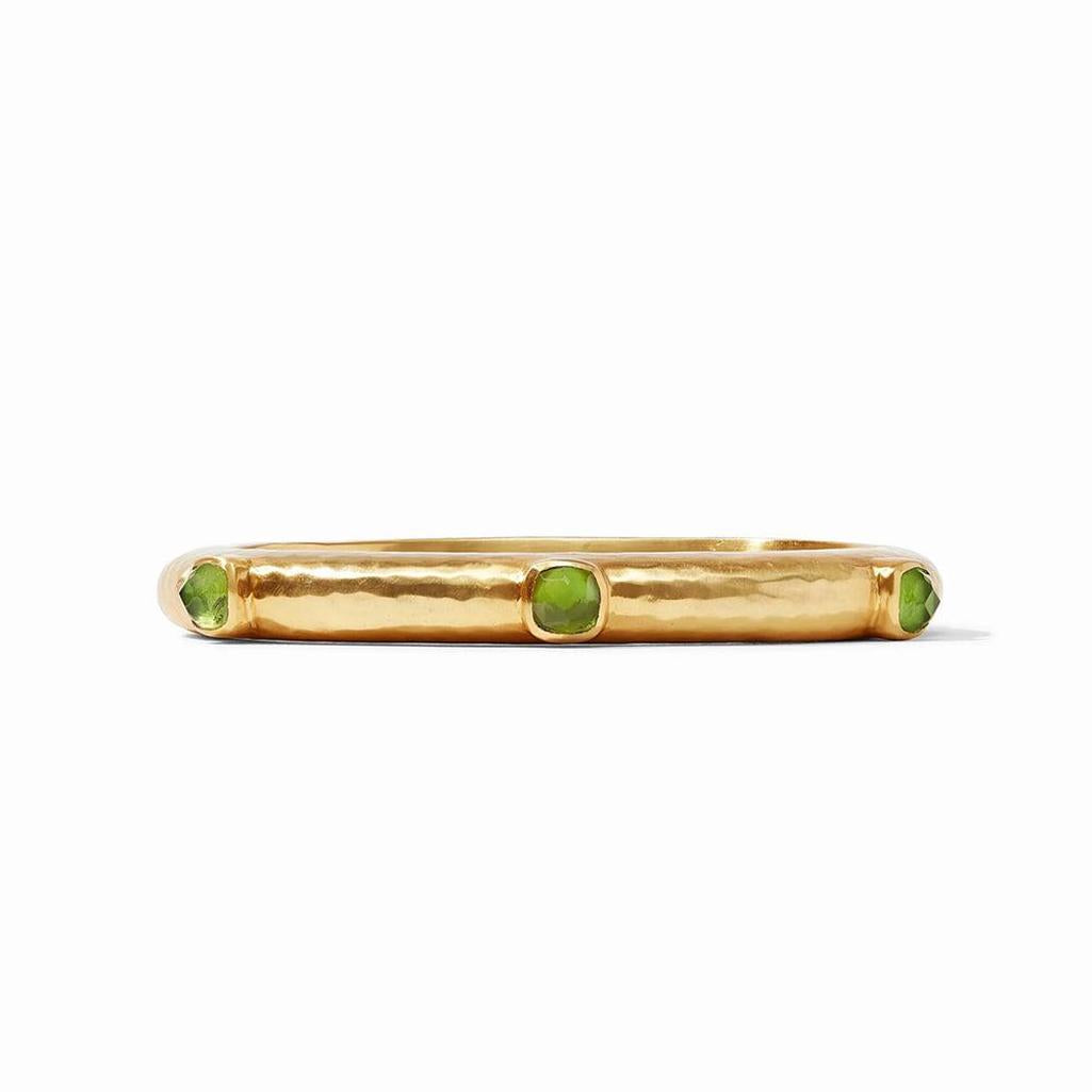 Gold hinged bangle featuring three green gemstones.
