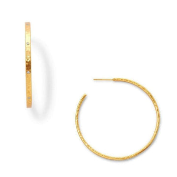 Gold hoop earrings with hammered texture and small diamonds.

