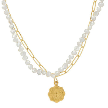 Dainty double strand necklace with white pearls, gold chain, and bee charm pendant.
