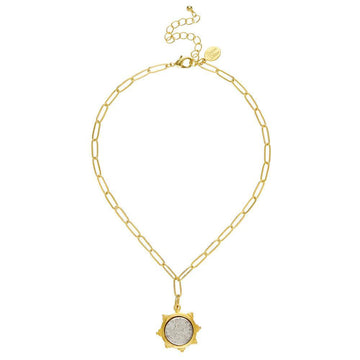 Gold chain necklace featuring a vintage coin pendant.
