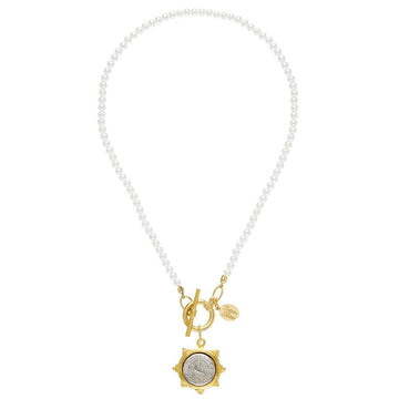 Elegant pearl necklace with gold coin pendant and toggle clasp.

