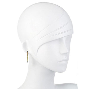 Long gold fringe earrings on a white mannequin.
