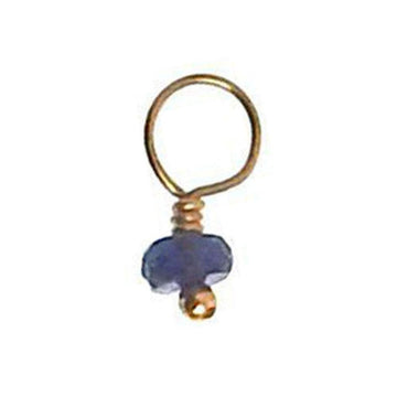 Purple gemstone pendant with gold wire accent
