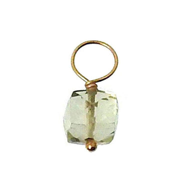 Green gemstone pendant with gold wire accents.
