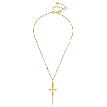 Gold cross necklace on delicate beaded chain.
