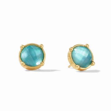 Gold stud earrings featuring round, teal gemstones.
