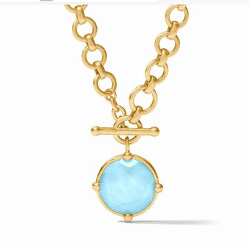 Gold toggle necklace with light blue gemstone pendant
