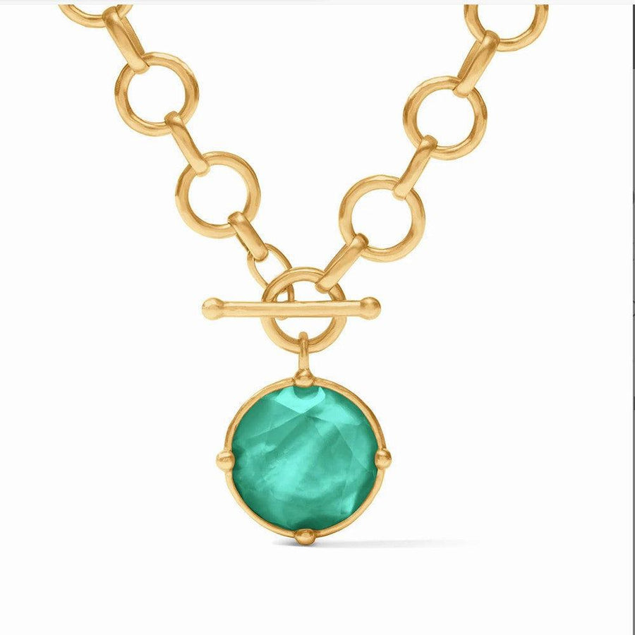 Gold chain necklace with teal gemstone pendant.
