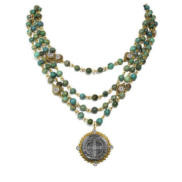 Three-strand turquoise bead necklace with gold accents and a detailed medal pendant.
