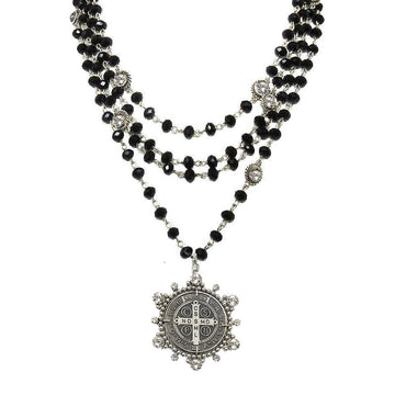 Layered black crystal necklace with a silver medallion pendant.
