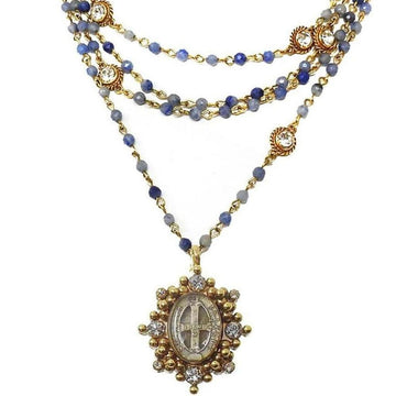 Layered blue gemstone necklace with gold accents and ornate pendant.
