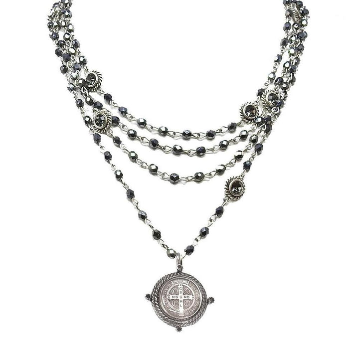 Multi-strand silver necklace with dark gray beads and a detailed pendant.
