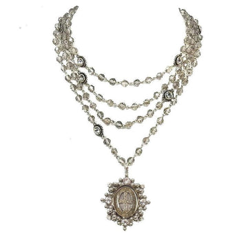 Multi-strand silver necklace featuring faceted beads and a detailed medallion pendant.
