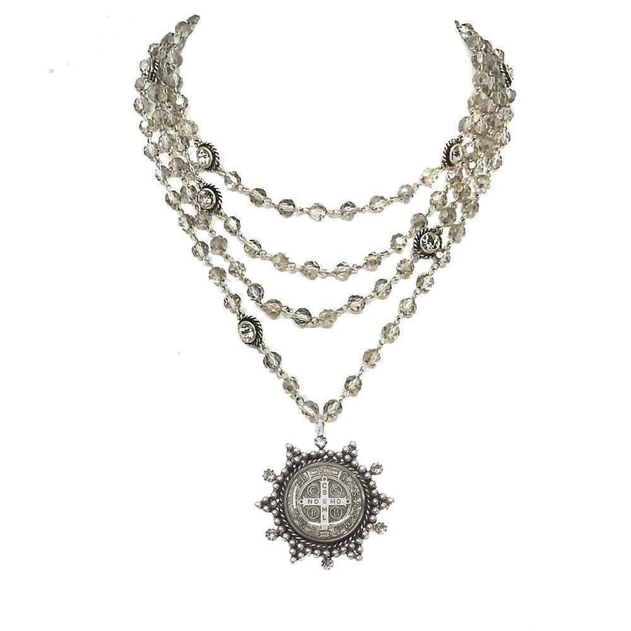 Multi-strand silver necklace with smoky quartz beads and a detailed medallion pendant.
