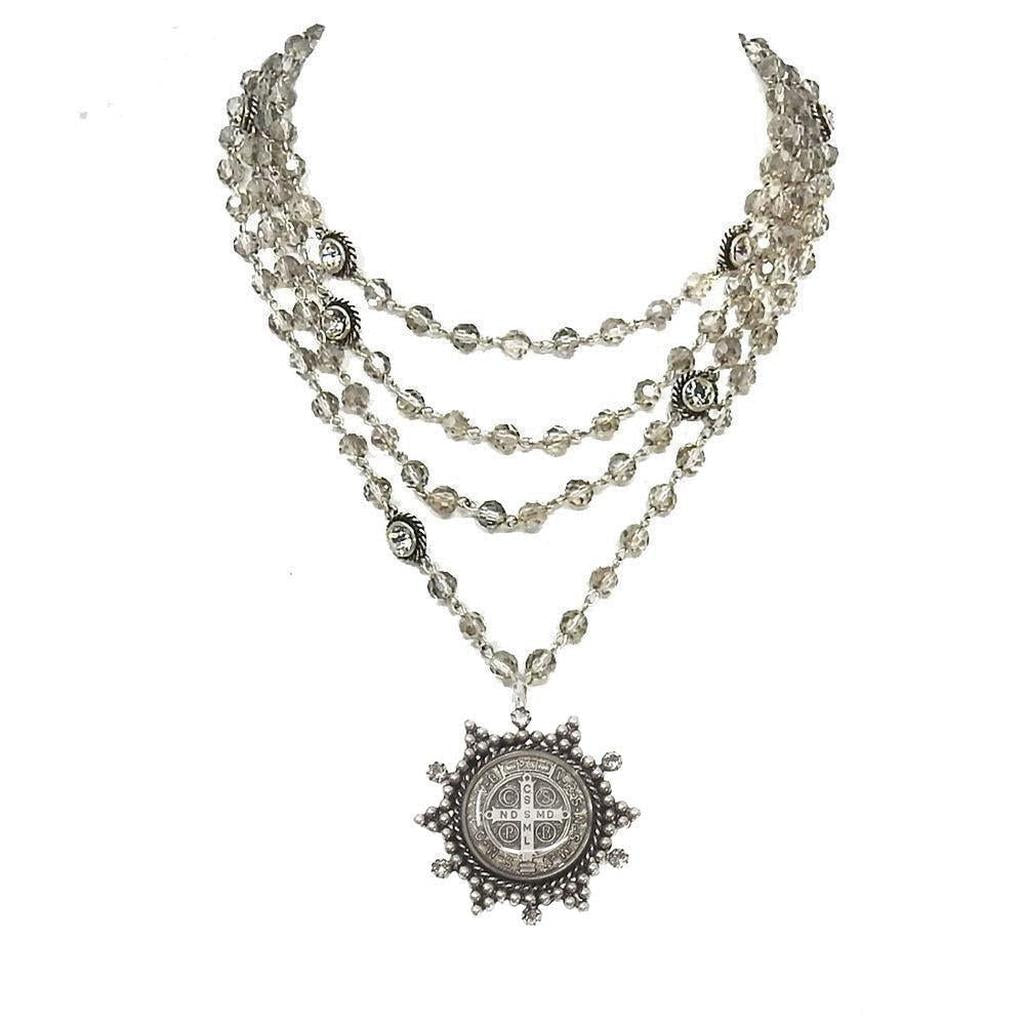 Multi-strand silver necklace with smoky quartz beads and a detailed medallion pendant.
