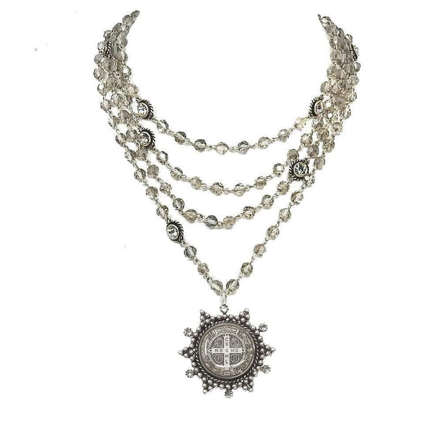 Multi-strand silver necklace with smoky quartz beads and a detailed medallion pendant.

