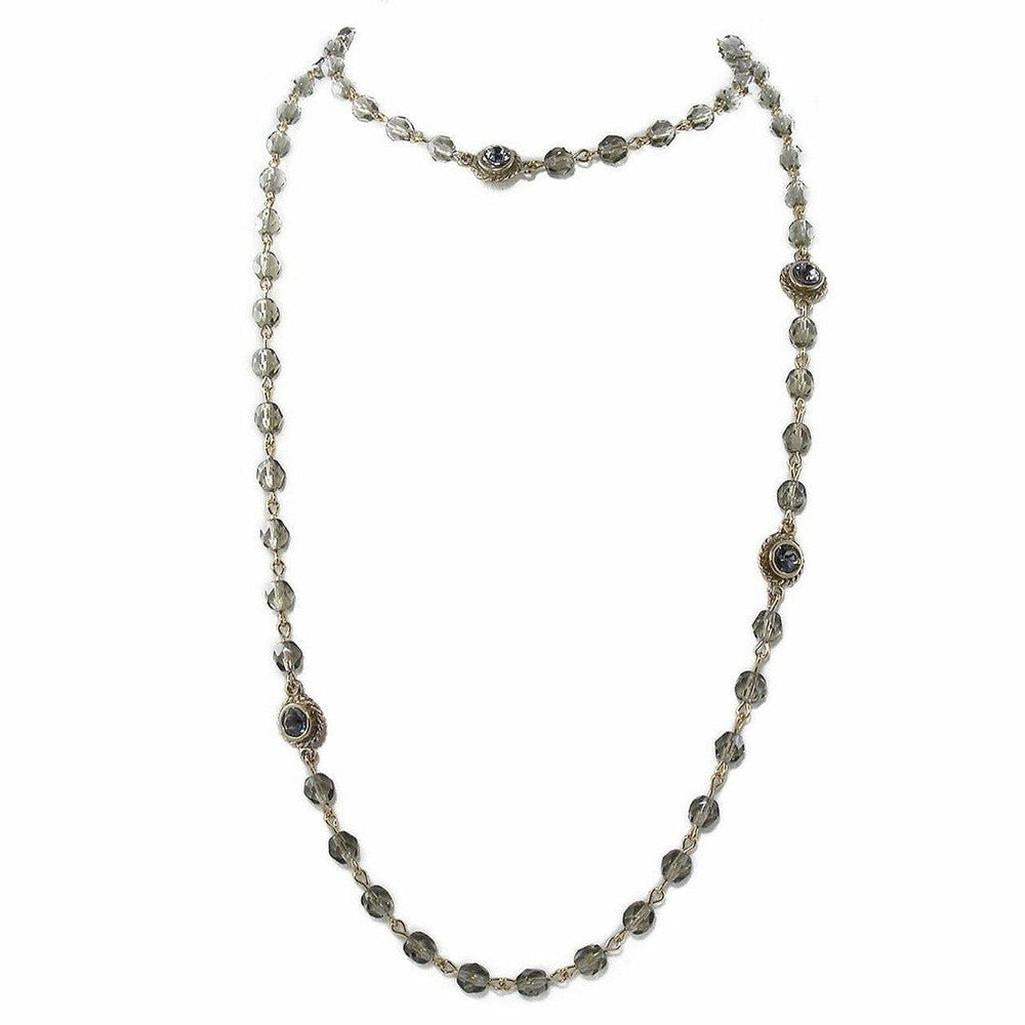 Gray glass bead necklace with gold accents.
