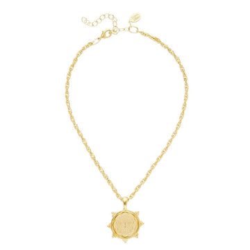 Gold rope chain necklace with ornate medallion pendant.
