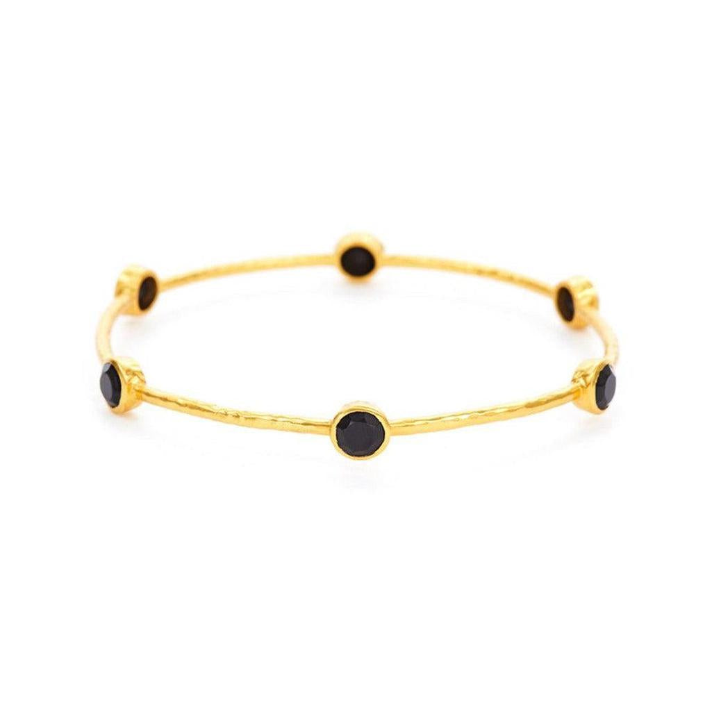 Gold bangle bracelet adorned with six black stones.
