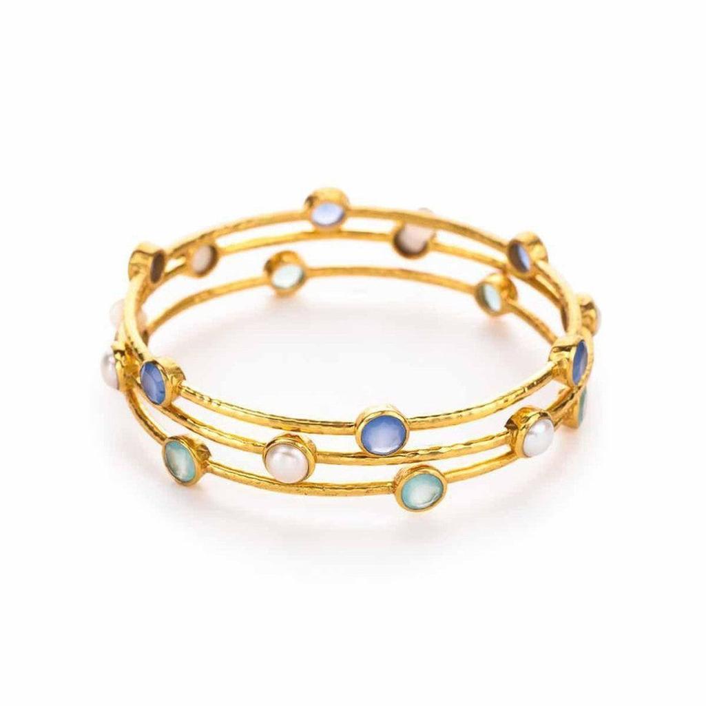 Triple gold bangle bracelet adorned with blue, green, and white stones.
