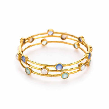Triple gold bangle bracelet adorned with blue, green, and white stones.
