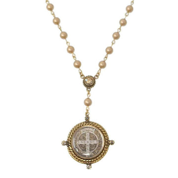 Elegant rosary necklace with creamy beads and ornate gold-toned medallion.
