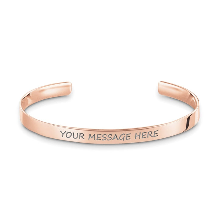 Rose gold cuff bracelet with customizable engraved message.
